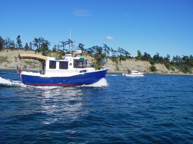 Mac on the "Island Ranger" headed into Fisherman's Bay, Lopez for opening weekend CBGT 07. Somebody in the far C-Dory is shooting back at us.  Wish we had a copy of that shot.