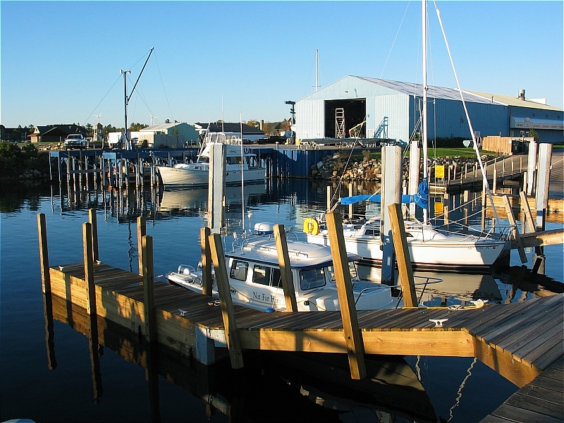 Mackinac City Harbor a few floating docks most dock too high many boats being pulled in Sept