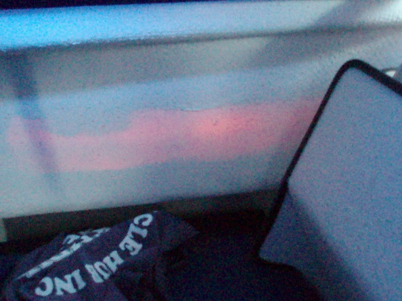 Maybe you CAN shine a flashlight from the outside and see it inside!  I think the coloring is actually from the red light on the portside exterior--odd looking, eh?