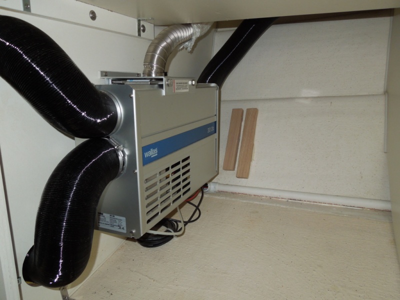 Mounted under forward passenger seat.
Coax exhaust /combustion line is only warm to the touch.