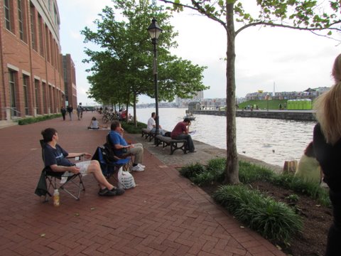 near Inner Harbor Area these people are getting to hear an area concert for free from across the water