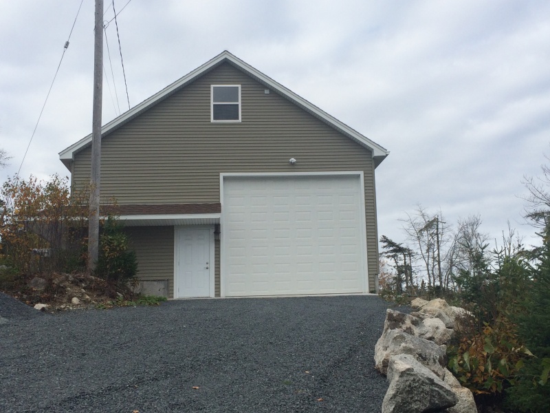 New Garage. (view from the east). Man Door and Boat access. Boat door is 14' high and 12' wide.