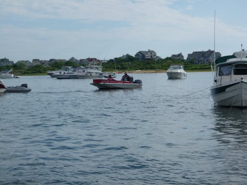 New Harbor in Block Island, this guy (Aldo) who bellows in  Italian,let's go and is selling pastries, breakfast sandwiches, bread all very good going boat to boat in the salt pond on Block Island. This place is packed for the fireworks on July 3rd. 1500 boats the town is packed great scenery of all kinds,I'm sitting on my boat loving life as I write this caption