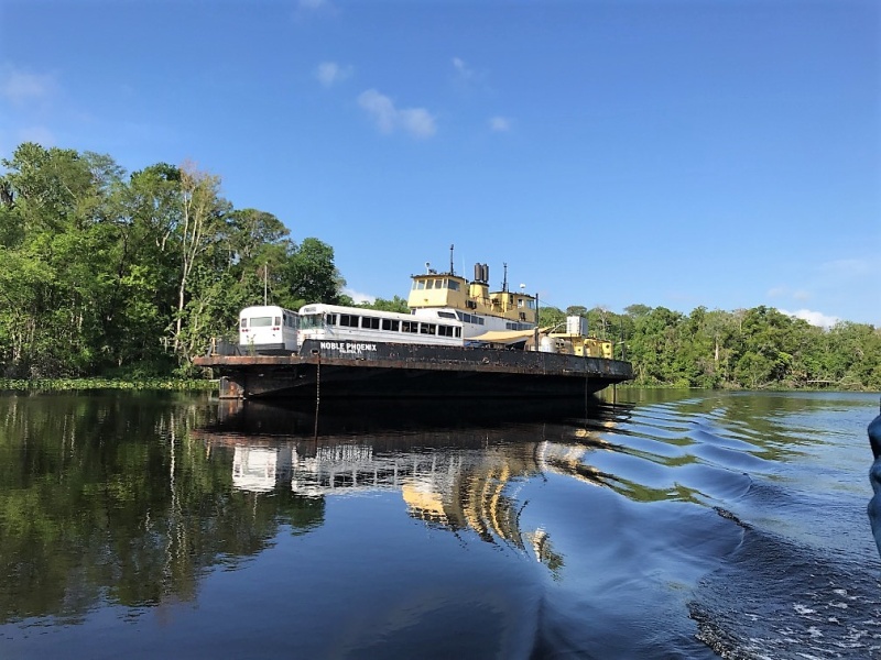 Noble Phoenix in Murphys Creek. Notice the AirStream trailer and two city buses on it\'s decks.