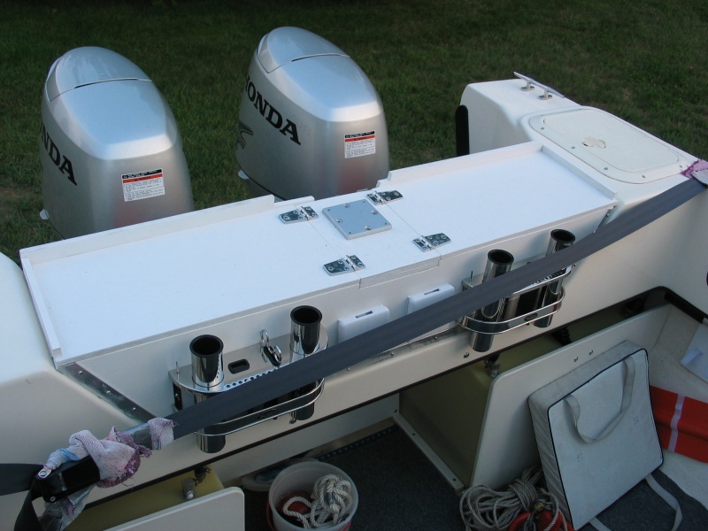 (Not For Hire) Anti-poop barrier board?and fishing shelf. Hinged access to fenders. Downrigger mount in center for third downrigger (need long boom for this one "down the chute." Downrigger mount reinforced with stainless rail beneath shelf.