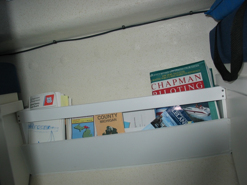 (Not For Hire) Magazine, chart, book rack under table.