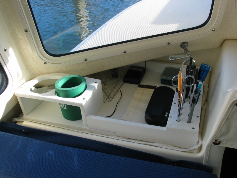 (Not For Hire) Portside dashboard organizer made of starboard. Knew my junk would all fall through to the v berth without this.