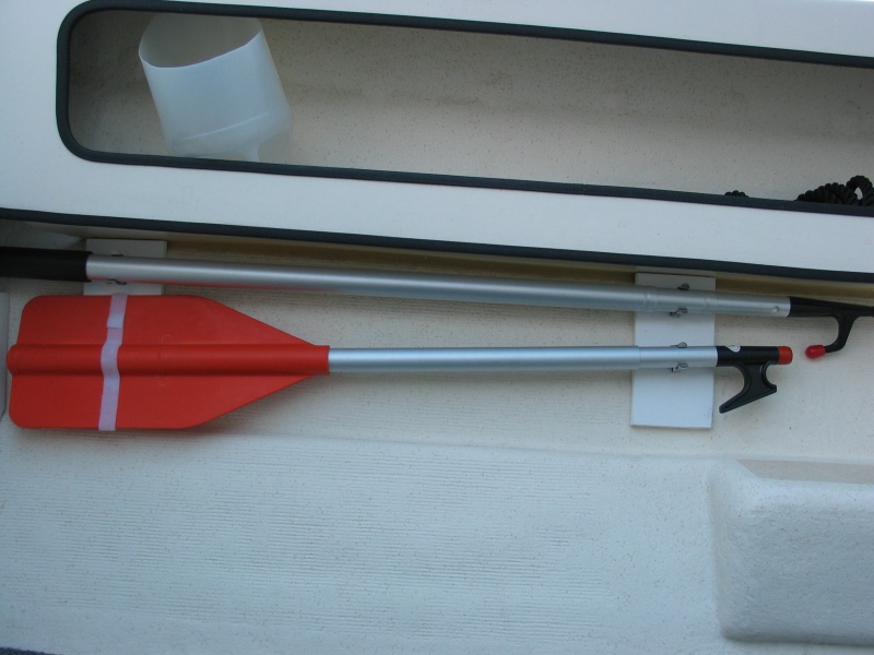 (Not For Hire) Two pieces of starboard glued to hull, screws and velcro on the starboard hold boat hook and paddle. Tested McNaughty style shelves but decided this was better for me.
