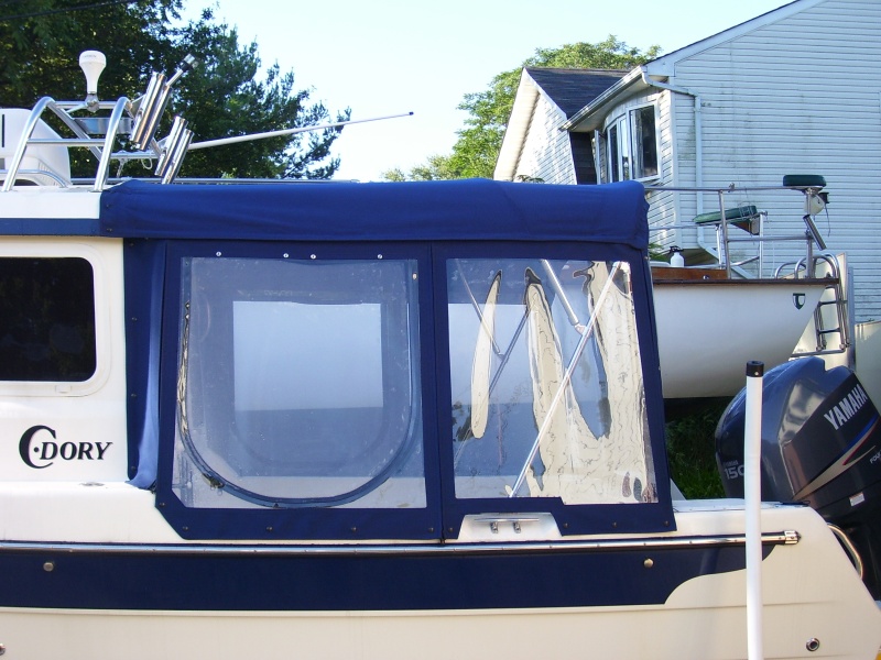 Notice level roof no step up. Windows and cabin roof are taller on the 23' Ventures. The top carries the boats curved roof contour. Where the canvas attaches to the boat the canvas has a slide in track plus a velcro seal and a zipper for easy removal. All the bows have zippers for easy on and off. The frame has quick disconnect pins that are tethered to the gunnel mounts.