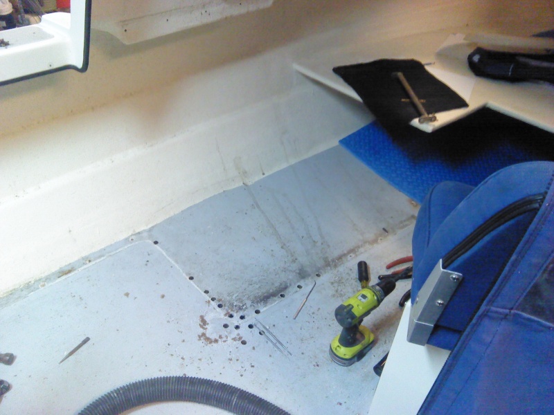 Once the port side seat box was removed, I could tell that there was a substantial problem.  You can see a white line of caulk that kept water (and dirt) up against the pop rivets.  I'm not sure what the little strip of caulking was intended to do.