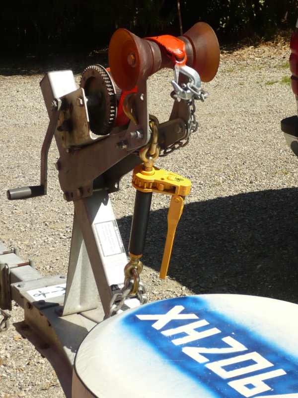 OOOPS INSPIRED: Added 7100Lb W/L heavy equipment ratchet chain binder (foldable handle) to tie down front end as second safety chain. Secured to bow post and main trailer beam with 1/2" galv. chain. Should not come up again (or forward) unless I lose the bow eye. Chain is linked under trailer with a full oval screw on connector and locked with a padlock as anti theft precaution. I'm not intending to put this in a thread until it has been well tested.