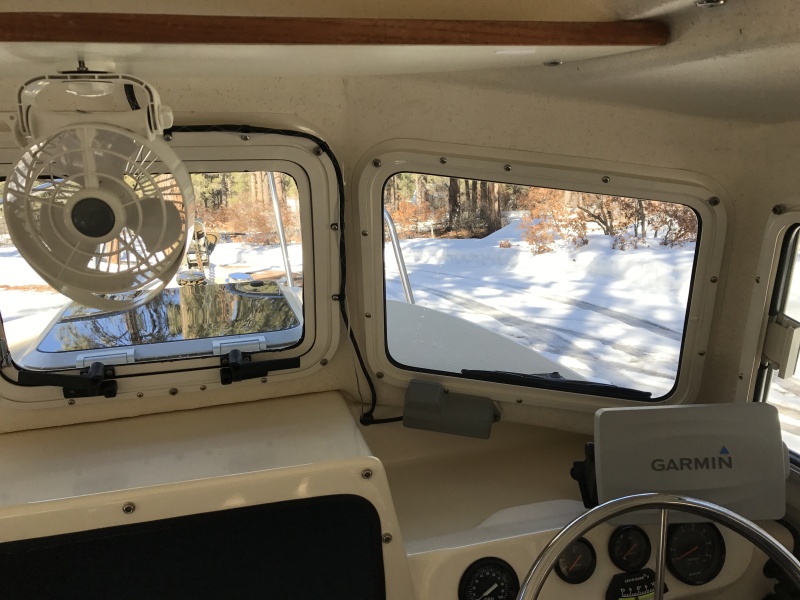 Opening center window, 12 volt fan and windshield wiper on port window.