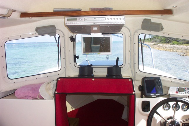 Our weekly grocery trip to Cayman Brac can be a long ride when the water is rough and we have to slow way down.  So Craig bought a DVD player to pass the time.
