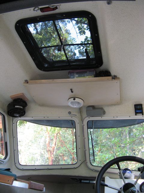 Overhead hatch with screen-- storage shelf forward. Red LED strip (less harsh for night use) installed to interior light circuit and OEM interior light moved forward (uses switch on light casing).