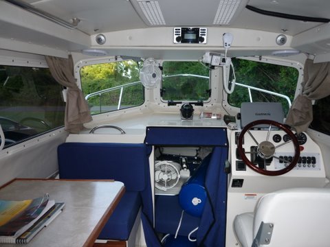 P1000482 berth fan is reversable and swings 180 degrees out of the way. Our stereo a Clarion CMD-06 AM,FM,CD has remote control which will control and charge an IPOD if it is plugged into the supplied USB cable which is routed in clips beside the helms windshield.