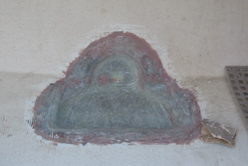 Pigmented resin coat removed; small holes drilled to drain nuisance water until I re-drill main drain hole.