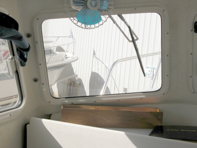 PIX shows the port side original 11.5" SS Deluxe wiper with the replacement arm. The new 14" wiper is now installed. It's adjusted parallel to the outside edge of the window and centered in its height.