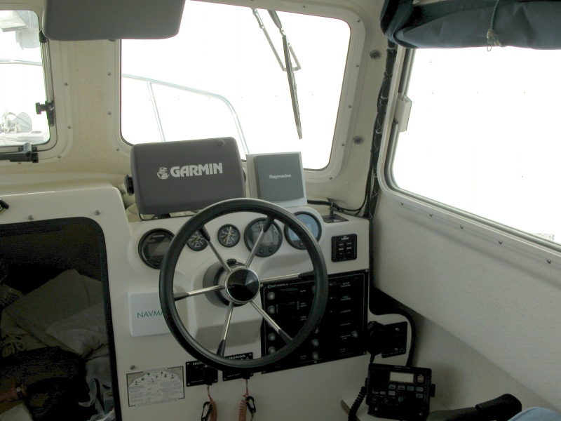 PIX shows the starboard side original 11.5" SS Deluxe wiper with the replacement arm. New 14" wiper is now installed. It's adjusted parallel to the outside edge of the window also it's centered in height.