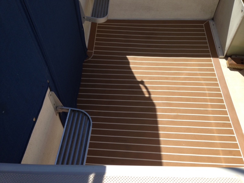 Plasdeck faux teak flooring. The color scheme was "Holly w/ white lines".