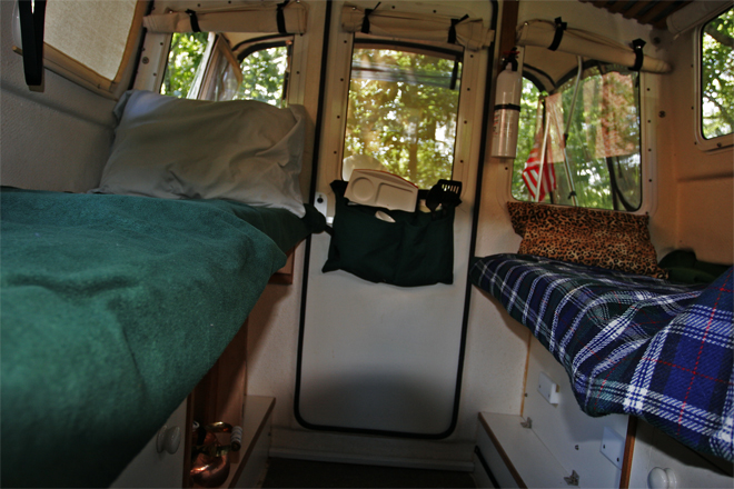 Port and Starboard Beds looking aft. The kitchen storage pocket is removed from the helm seat back and snapped to the cabin door when the starboard bed is setup.