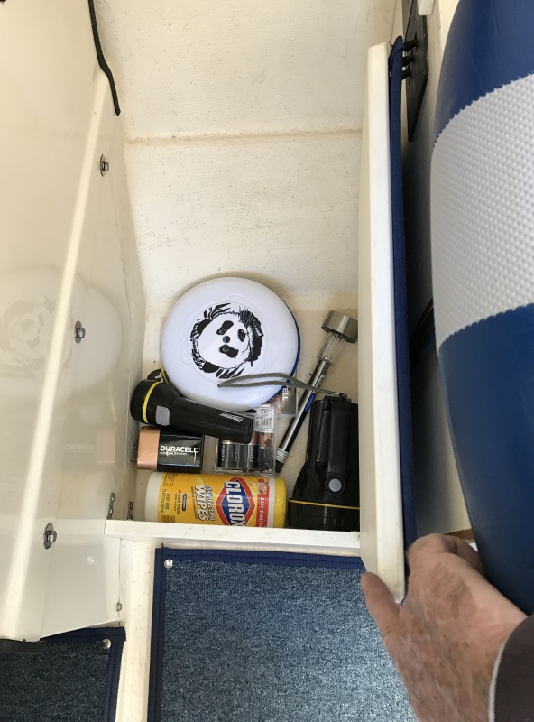 Port foot locker in front of helm seat.