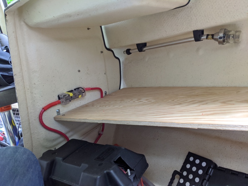 Port-side cuddy shelf. 3/4\" marine plywood. The long edge rests on the hull chine shape.