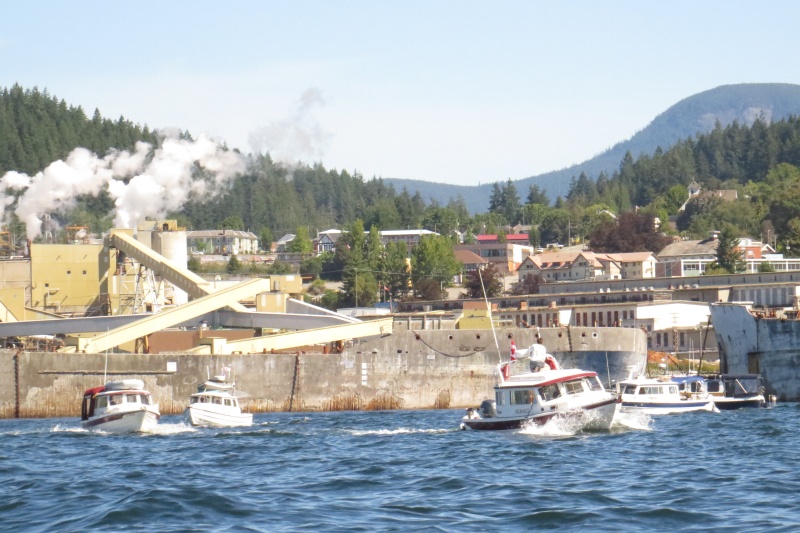 Powell River cement WW11 cement freighters used as break waters for the mill since 1950. Paper mill and townsite in background.  Mill is over 100 years old.  Now employs 300+ people only.