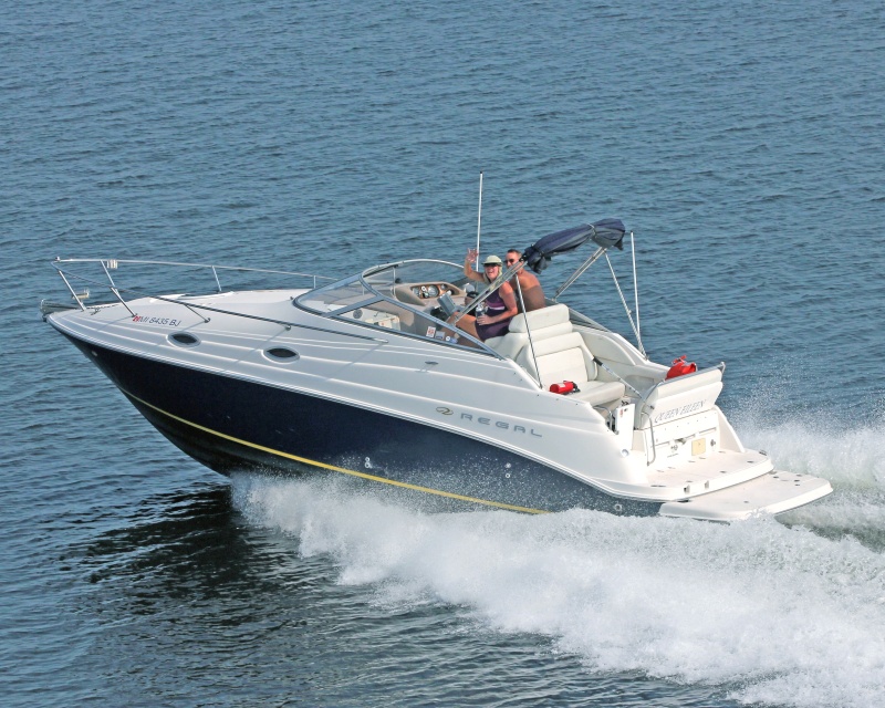 Prior trailer boat #12 (Regal 2665) on Pensacola Bay.  Professional photographer leaning out of a helicopter with one foot on the rail, on a gunners' belt.  Do Not try this at home.
