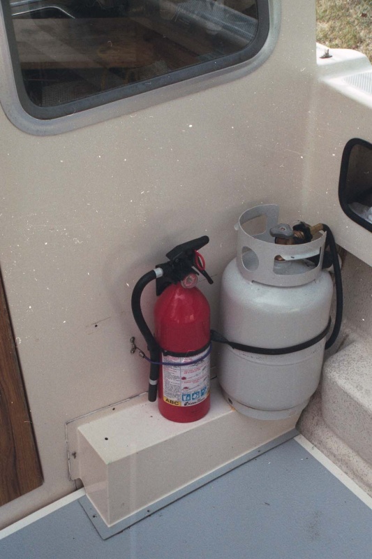 Propane tank mount. Rubber snubber hooked to stainless eyes.