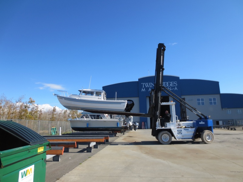 Putting boat on the stand to be washed down.