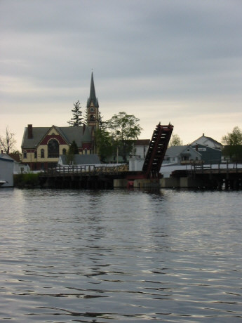 Railroad draw bridge and churh at tip of Paugus Bay.