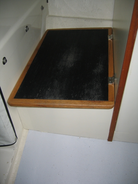 Raised step to helm 2 1/8 inch and replaced lid -- adds a little storage room.