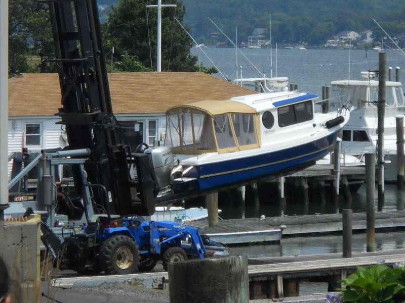 Ready for launch into orbit -- well, here the Betty Ann is on a fork lift to be brought back into the valet storage building.  The Betty Ann is pampered -- stored inside so as to be protected from the ravages of UV light.  It will also not be undercoated, so our hull will be more slippery in the water to ensure higher fuel efficiency.  Lastly, we get hurricanes in Connecticut, so it will be protected from storm surges.