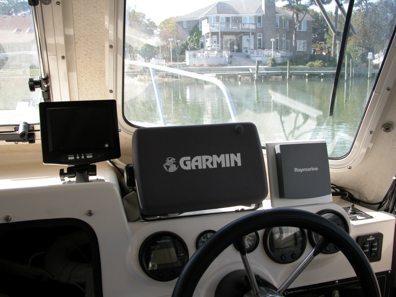 Rear view cockpit camera LCD monitor positioned to the left of the GARMIN 2006C display. Though the location was best for viewing, it proved not so because of water spray when the center window is open.