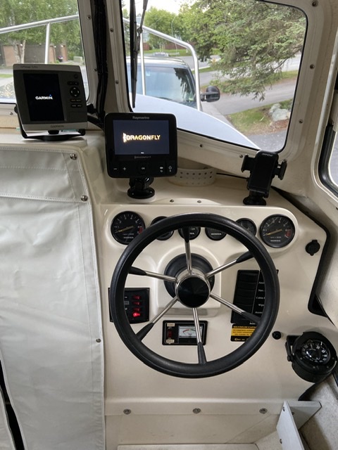 Reconfigured dash with compass down low, two chart plotters, and phone mount