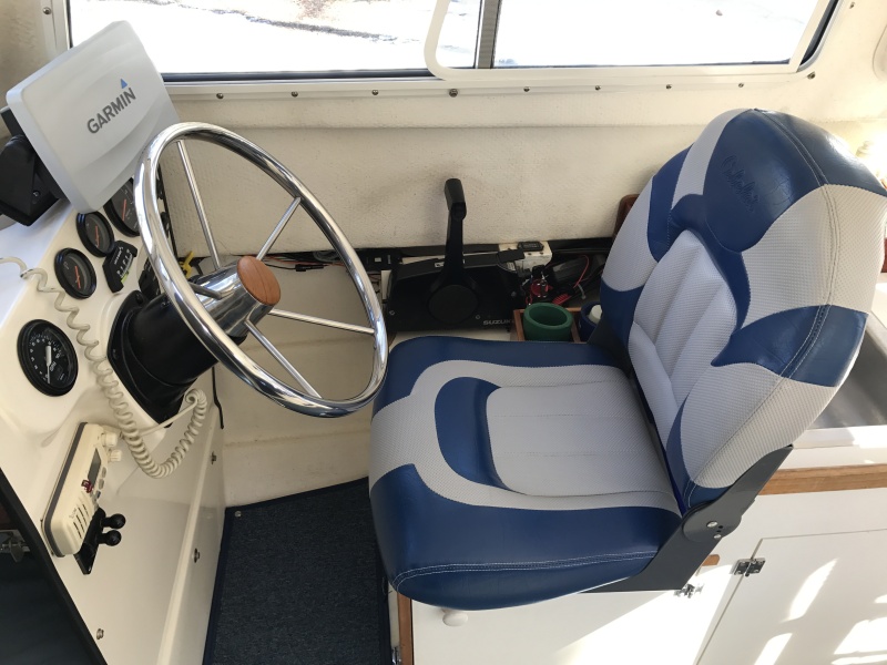 Replaced standard helm station seat with Cabela's Pro Fisherman High-Back Seat and added 20 degree wedge to steering wheel for additional leg room.