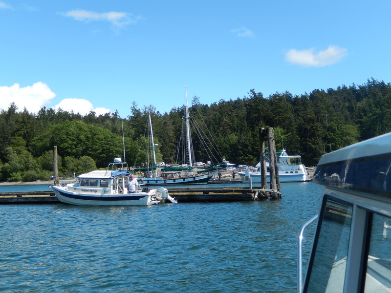 Rob on Robbie's Refuge greeting See-Saw and crew 
at the dock in Cornet Bay on Whidbey Island--
the end of a beautiful cruise