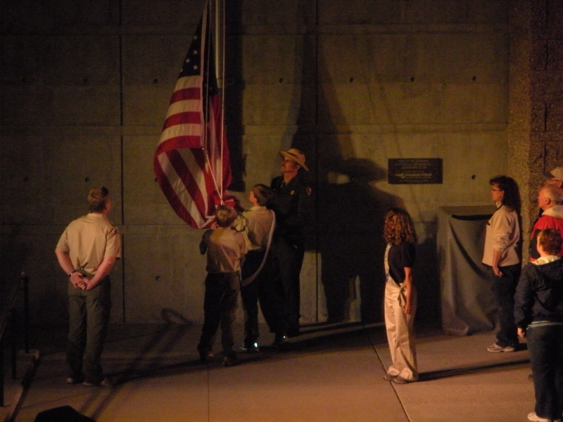 Scouts lowering and folding the flag at Mt. Rushmore evening ceremony.