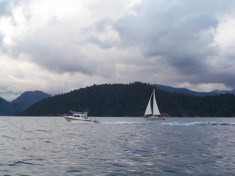 (seabran) We crossed the Straight of Georgia with Bambina and Anita Marie. Here Anita Marie is blowing past a sailboat as we head for Roscoe Bay. Notice the dark clouds?