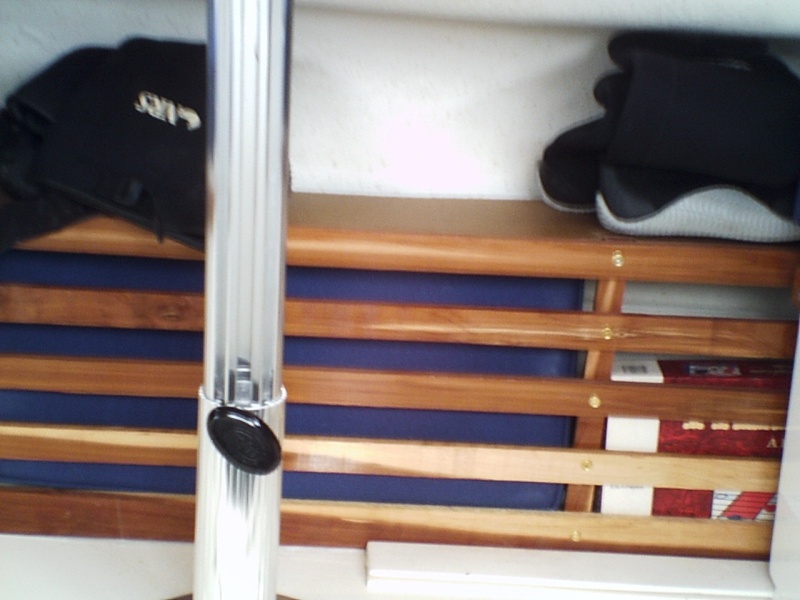See through stowage area between seats and port bulkhead.  Cut-to-fit piece of wood lays in top to facilitate better use of the area