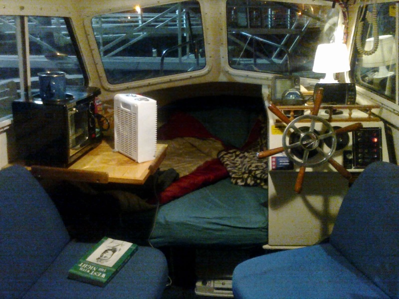 Set for the night.  Note how bright it is outside the boat.  This is not due to daylight, the marina has big lights at the seawall.  Curtains are first order of business today.