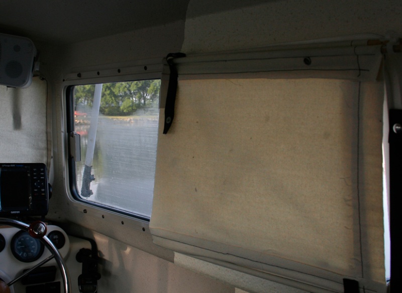 Shade is split to allow air circulation from forward side windows. Shade is made from canvas with dowel rods on top and bottom to allow easy rollup.