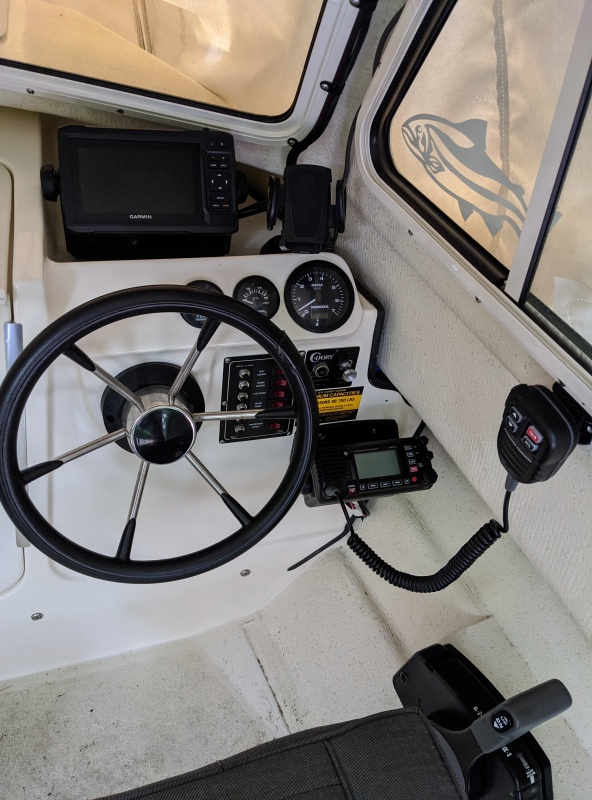 Showing Chartplotter, VHF, VHF mike, and cell phone holder.