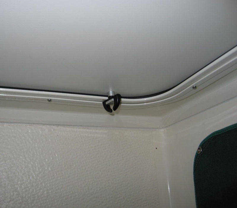 Single (window) turn catch located at base of shower door opposite the hinge side will hold lower part of door tight against the sealing gasket eliminating "all" leaks.  Several 1/8" drain holes were drilled in the aluminum door frame just above the lower gasket to duct the small amount of water that collects between door and frame back to shower stall.  The catch was slightly modified to permit opening by screw driver from the outside if necessary and for correct spacing.
