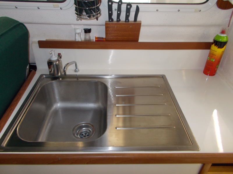 sink with very handy drain board. Note the small toggle switch by soap bottle.
electric water pump.