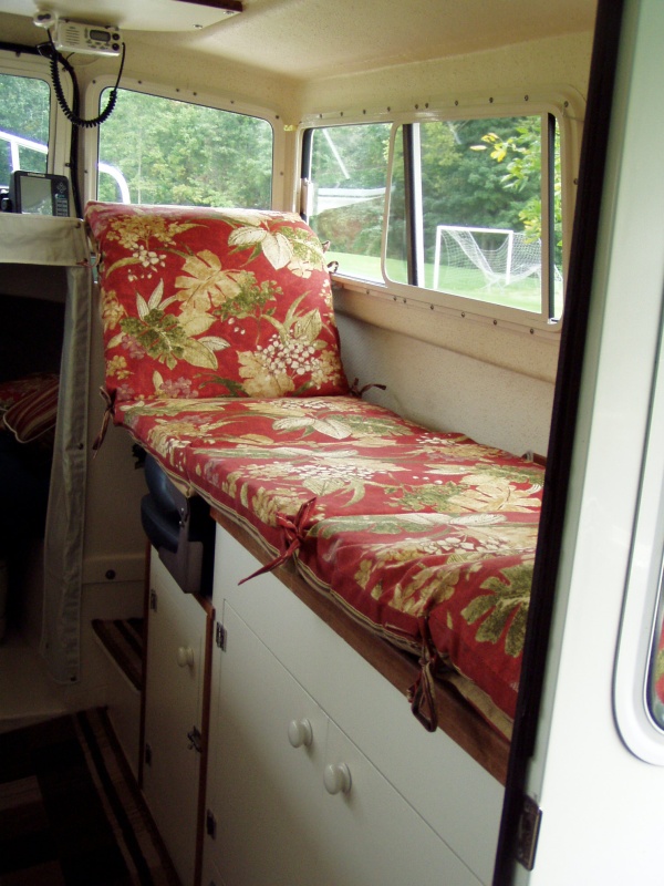 Sofa Cushions Placed Across Galley Top + High Back Flat-folding Helm Seat Make Child's Bed