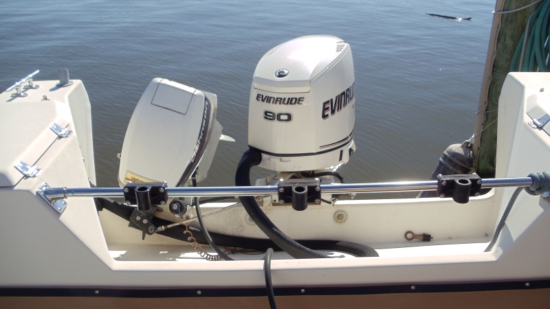 Stainless bar across motor well with three Scotty rod holders included. Two brand new holders never used.