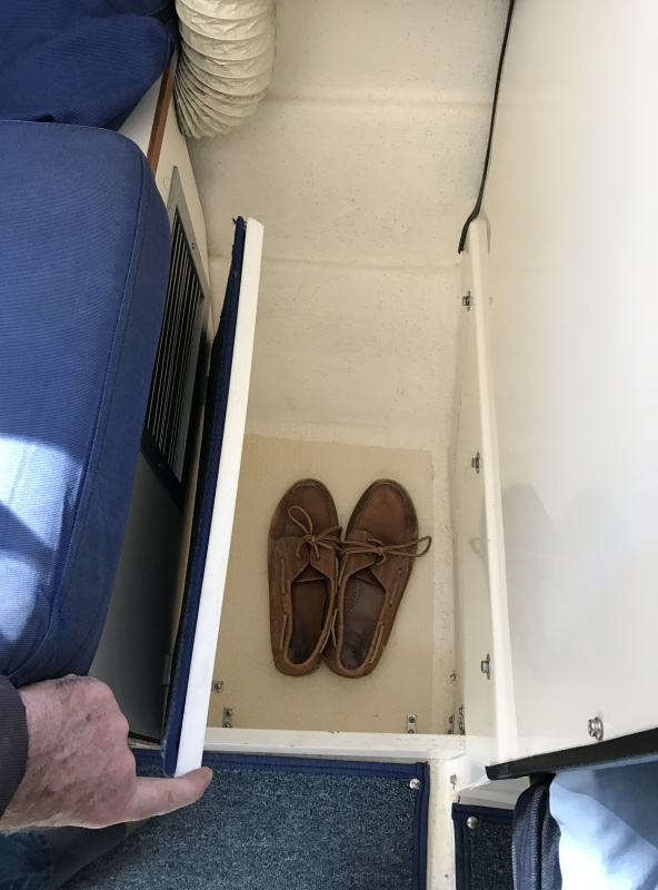 Starboard foot locker in front of passenger seat.