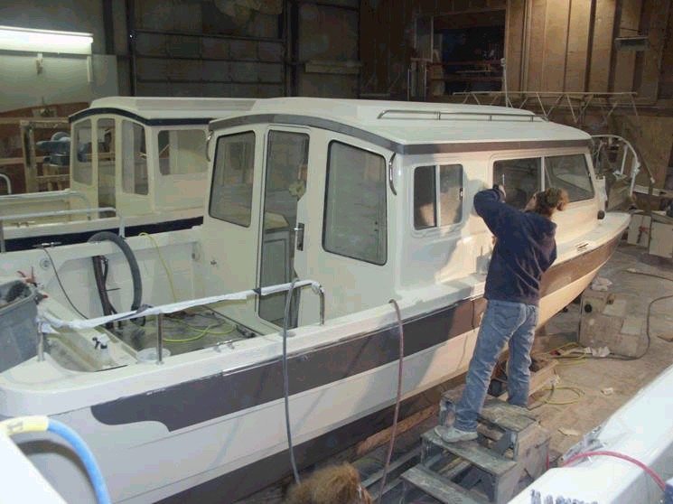 Starboard side work. Buffing the upper half. Note: all rails and cleats are in place. 3/15/04