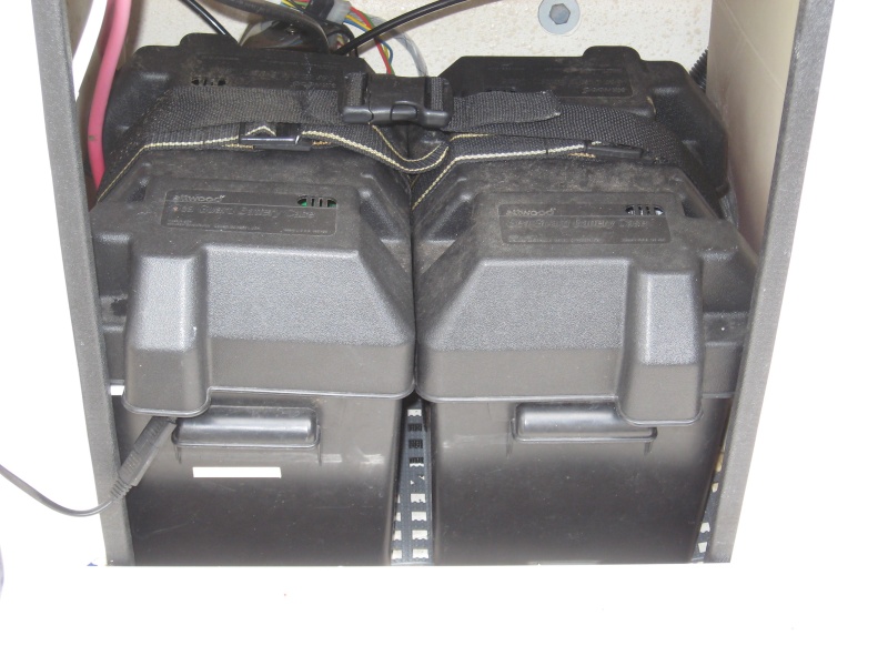 start and house battery on dri deck and strapped to epoxy bonded ss loops to floor, cables long enough to bring batteries out onto cockpit floor to maintain